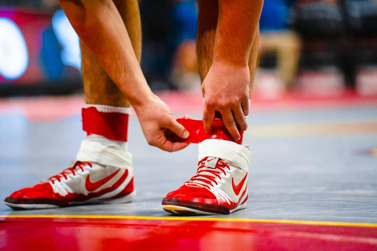 Wrestler adjusting his shoes